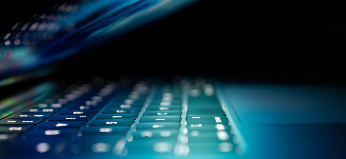 closeup photo of turned-on blue and white laptop computer